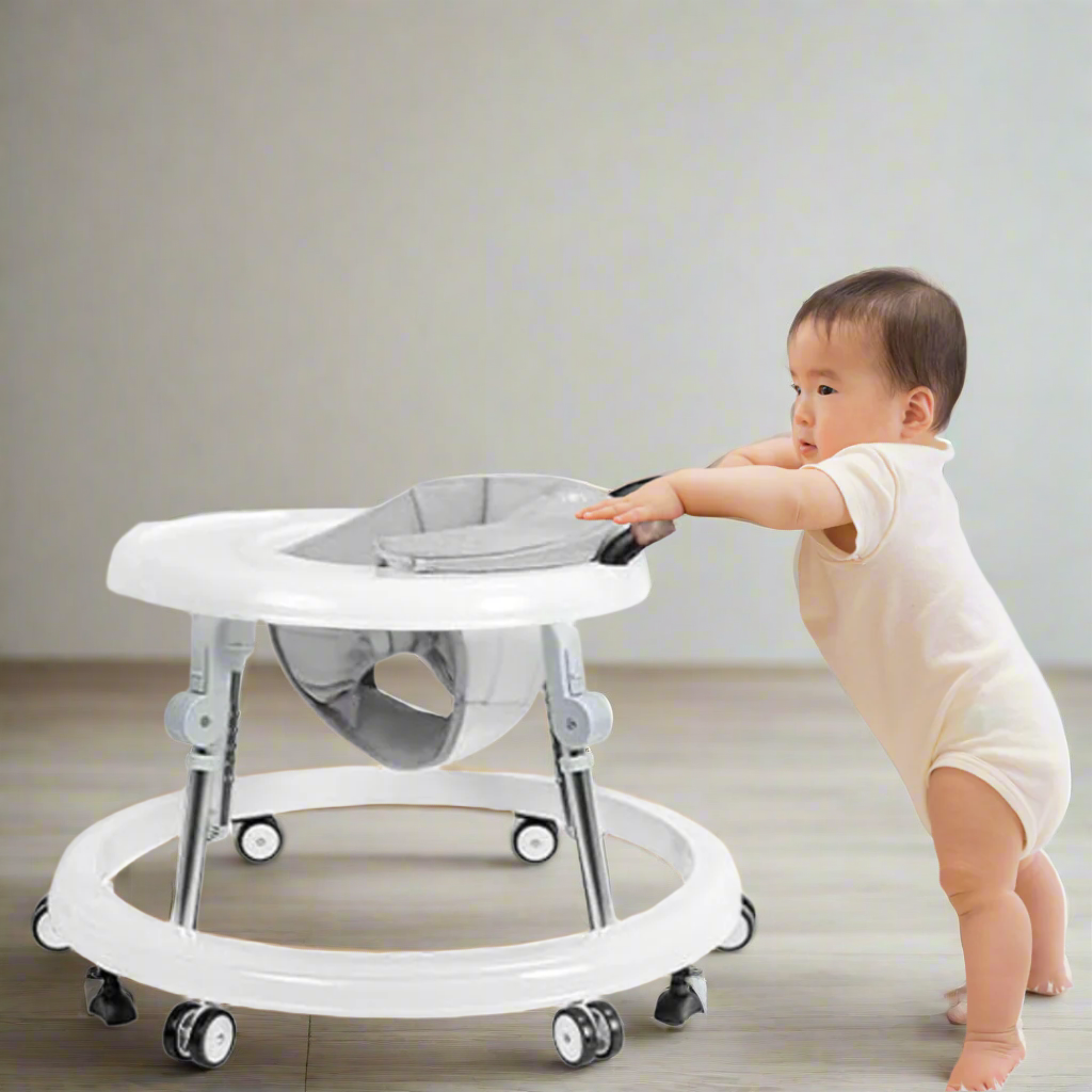 Baby standing next to a baby walker on a white background